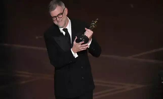 Paul Thomas Anderson accepts the award for directing for "One Battle After Another" during the Oscars on Sunday, March 15, 2026, at the Dolby Theatre in Los Angeles. (AP Photo/Chris Pizzello)