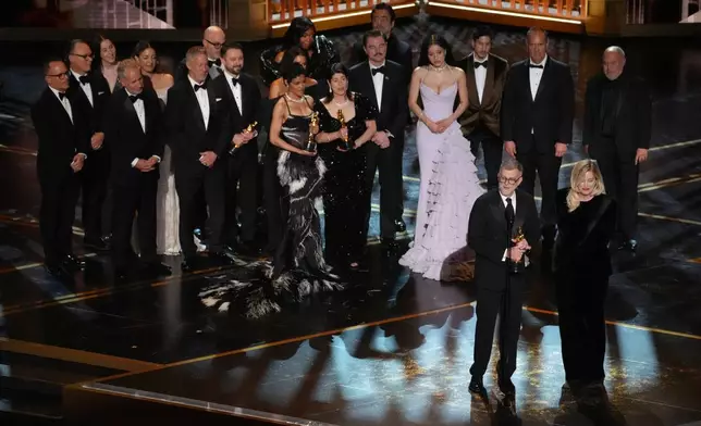Paul Thomas Anderson, left center, Sara Murphy, right center, and the team from "One Battle After Another" accept the award for best picture during the Oscars on Sunday, March 15, 2026, at the Dolby Theatre in Los Angeles. (AP Photo/Chris Pizzello)
