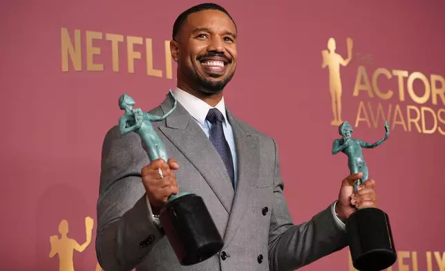 Michael B. Jordan poses with the awards for outstanding performance by a male actor in a leading role and outstanding performance by a cast in a motion picture for "Sinners" during the 32nd Annual Actor Awards on Sunday, March 1, 2026, at the Shrine Auditorium and Expo Hall in Los Angeles. (Photo by Jordan Strauss/Invision/AP)