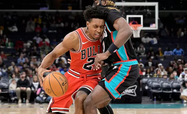 Chicago Bulls guard Collin Sexton (2) drives against Memphis Grizzlies guard Jahmai Mashack, right, in the first half of an NBA basketball game Saturday, March 28, 2026, in Memphis, Tenn. (AP Photo/Brandon Dill)