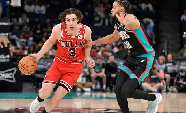 Chicago Bulls guard Josh Giddey (3) handles the ball against Memphis Grizzlies guard Rayan Rupert (32) in the first half of an NBA basketball game Saturday, March 28, 2026, in Memphis, Tenn. (AP Photo/Brandon Dill)