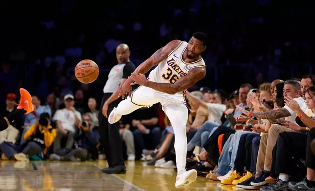 Los Angeles Lakers guard Marcus Smart (36) stops the ball from going out of bounds during the first half of an NBA basketball game against the New York Knicks, Sunday, March 8, 2026, in Los Angeles. (AP Photo/Caroline Brehman)