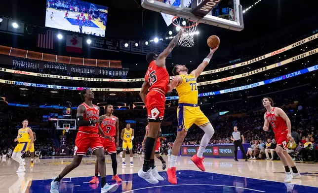 Los Angeles Lakers guard Luka Doncic (77) goes to the basket during the first half of an NBA basketball game against the Chicago Bulls, Thursday, March 12, 2026, in Los Angeles. (AP Photo/Ethan Swope)