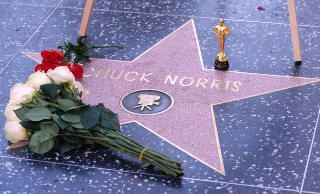 A toy Oscar is left on the Hollywood Walk of Fame star of the late actor Chuck Norris, who died Thursday at 86, Friday, March 20, 2026, in Los Angeles. (AP Photo/Chris Pizzello)