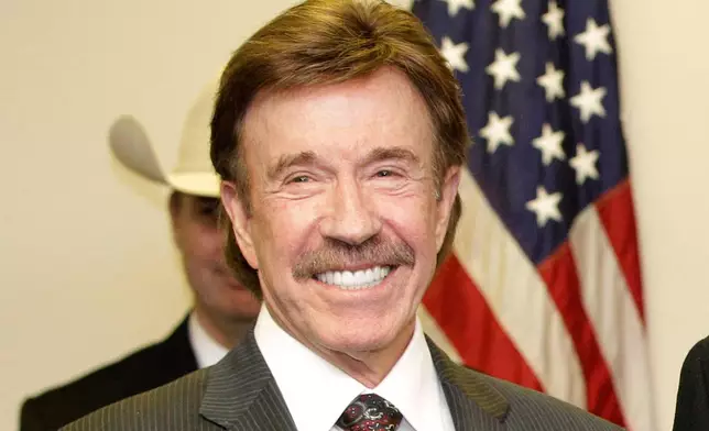 FILE - Chuck Norris appears at a ceremony in Garland, Texas on Dec. 2, 2010. (AP Photo/Tony Gutierrez, File)
