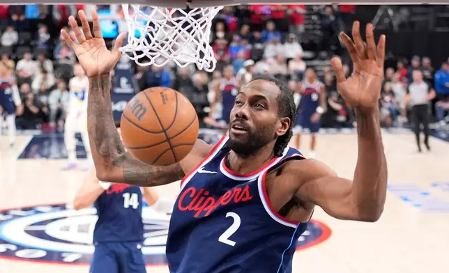 Los Angeles Clippers forward Kawhi Leonard dunks during the first half of an NBA basketball game against the Indiana Pacers, Wednesday, March 4, 2026, in Inglewood, Calif. (AP Photo/Mark J. Terrill)