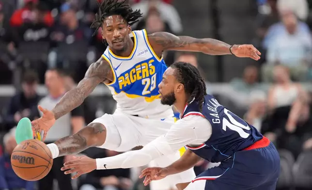 Los Angeles Clippers guard Darius Garland, right, tries to pass while under pressure from Indiana Pacers guard Quenton Jackson during the first half of an NBA basketball game Wednesday, March 4, 2026, in Inglewood, Calif. (AP Photo/Mark J. Terrill)
