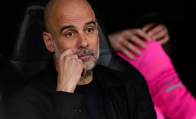 Manchester City's head coach Pep Guardiola sits on the bench before a first leg round of 16 Champions League soccer match between Real Madrid and Manchester City in Madrid, Spain, Wednesday, March 11, 2026. ((AP Photo/Jose Breton)