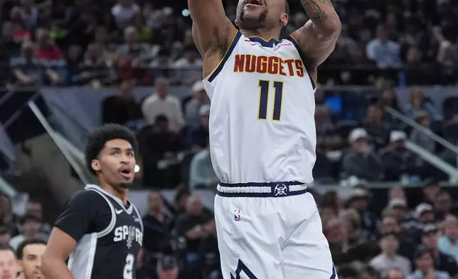 Denver Nuggets guard Bruce Brown (11) drives to the basket against the San Antonio Spurs during the first half of an NBA basketball game in San Antonio, Thursday, March 12, 2026. (AP Photo/Eric Gay)