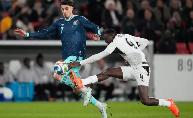 Kai Havertz of Germany is fouled by Jonas Adjetey of Ghana during an international friendly soccer match between Germany and Ghana in Stuttgart, Germany, Monday, March 30, 2026. (AP Photo/Matthias Schrader)