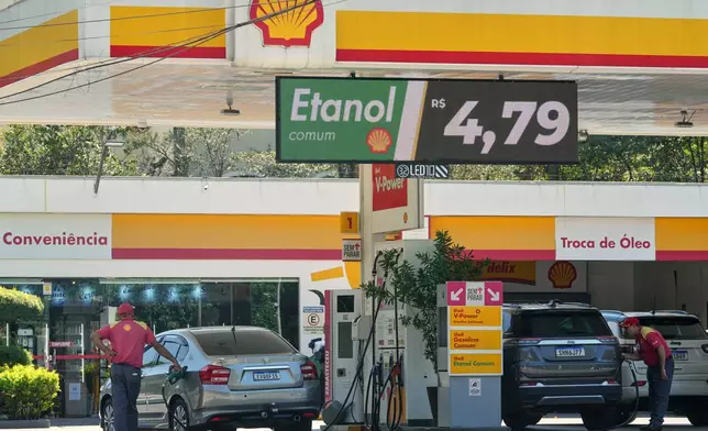 Cars fuel up with ethanol at a gas station in Sao Paulo, Friday, March 27, 2026. (AP Photo/Andre Penner)