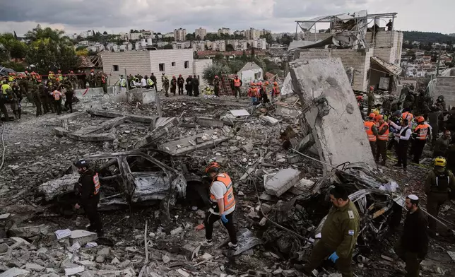 FILE - Rescue workers and military personnel operate at the scene where several people were killed in an Iranian missile strike in Beit Shemesh, Israel, Sunday, March 1, 2026. (AP Photo/Leo Correa, File)