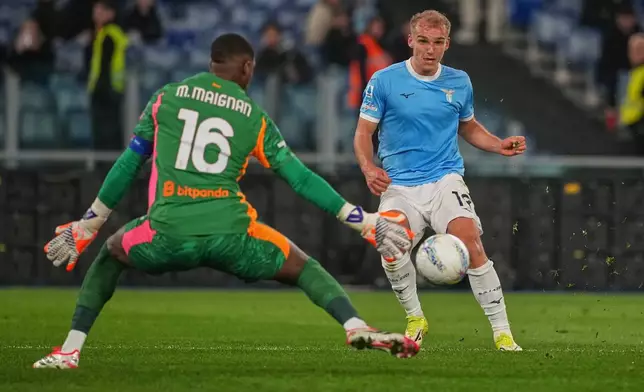 Lazio's Gustav Isaksen scores his side's opening goal past AC Milan's goalkeeper Mike Maignan during a Serie A soccer match between Lazio and Milan, in Rome, Sunday, March 15, 2026. (AP Photo/Andrew Medichini)