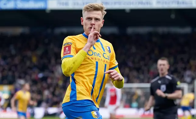 Mansfield's Will Evans celebrates after scoring his side's first goal during the English FA Cup soccer match between Mansfield Town and Arsenal in Mansfield, England, Saturday, March 7, 2026.(AP Photo/Dave Thompson)