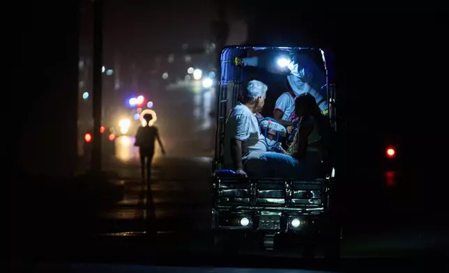 An electric tricycle transports customers during a blackout in Havana, Cuba, Saturday, March 21, 2026. (AP Photo/Ramon Espinosa)