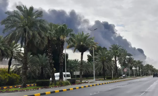 Smoke rises from Kuwait international airport after a drone strike on fuel storage in Kuwait City, Kuwait, Friday, Wednesday, March 25, 2026. (AP Photo)