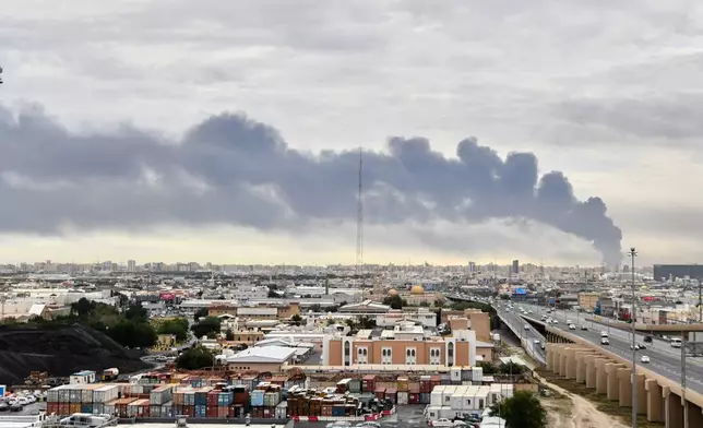 Smoke rises from Kuwait international airport after a drone strike on fuel storage in Kuwait City, Kuwait, Friday, Wednesday, March 25, 2026. (AP Photo)