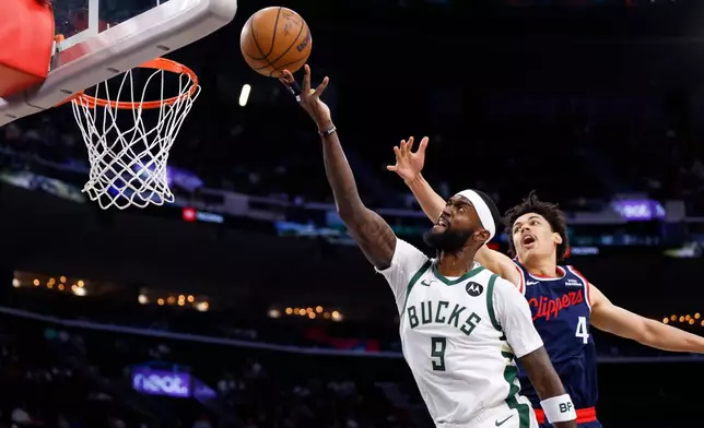 Milwaukee Bucks forward Bobby Portis (9) drives to the basket with the ball while being guarded by LA Clippers guard Kobe Sanders (4) during the first half of an NBA basketball game Monday, March 23, 2026, in Inglewood, Calif. (AP Photo/Caroline Brehman)