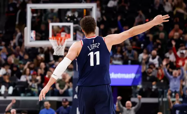LA Clippers center Brook Lopez (11) reacts after scoring a three-pointer during the second half of an NBA basketball game against the Milwaukee Bucks, Monday, March 23, 2026, in Inglewood, Calif. (AP Photo/Caroline Brehman)