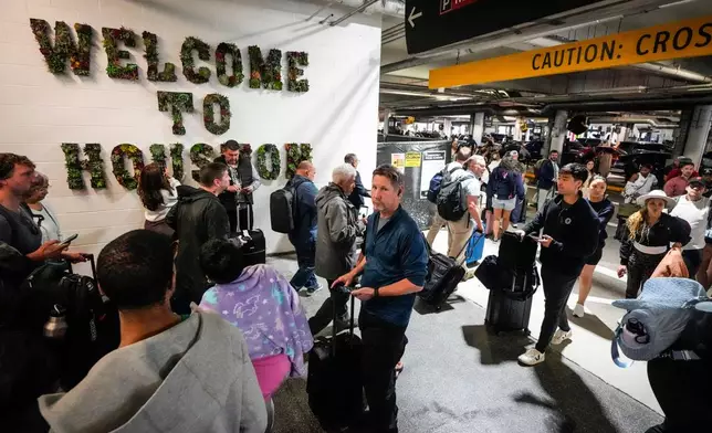 Airline passengers wait in long lines outside the terminal to get through the TSA security screening at William P. Hobby Airport in Houston, Sunday, March 8, 2026. (Brett Coomer/Houston Chronicle via AP)