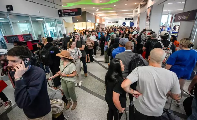 Airline passengers wait in long lines to get through the TSA security screening at William P. Hobby Airport in Houston, Sunday, March 8, 2026. (Brett Coomer/Houston Chronicle via AP)