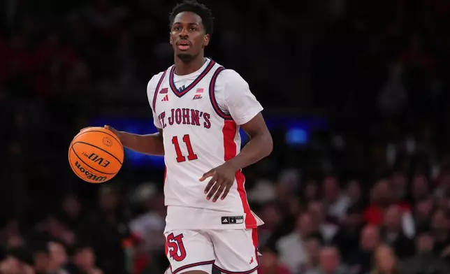 St. John's Red Storm's Ian Jackson (11) looks to pass during the second half of an NCAA college basketball game against the Georgetown Hoyas Tuesday, March 3, 2026, in New York. (AP Photo/Frank Franklin II)