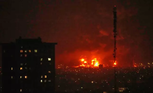 Flames rise from an oil storage facility south of the capital Tehran as strikes hit the city during the U.S.–Israel military campaign, Iran, Saturday, March 7, 2026. (AP Photo/Vahid Salemi)