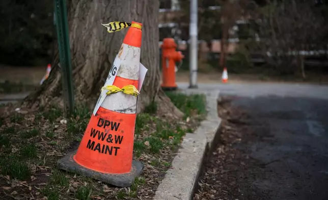 A cone with the letters of the Baltimore City Department of Public Works, which managers the city's wastewater services is visible on March 5, 2026. (AP Photo/Michael Phillis)