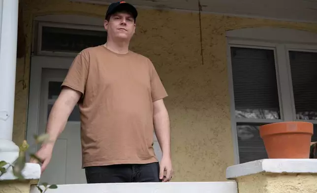 Teddy Bloomquist, who suffered a sewage backup earlier this year, poses at his home in Baltimore on March 5, 2026. (AP Photo/Michael Phillis)