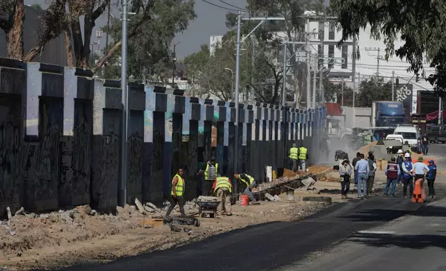 Workers prepare the ground outside the Azteca Stadium, 100 days before the opening ceremony of the 2026 FIFA soccer World Cup in Mexico City, Tuesday, March 3, 2026. (AP Photo/Fernando Llano)