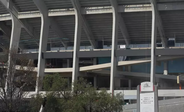 Workers load a truck with debris outside of the Azteca Stadium, 100 days before the opening ceremony of the 2026 FIFA soccer World Cup, in Mexico City, Tuesday, March 3, 2026. (AP Photo/Fernando Llano)