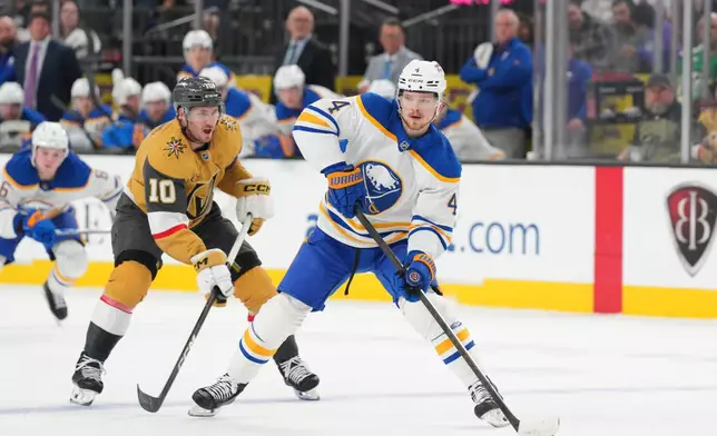 Buffalo Sabres defenseman Bowen Byram (4) skates with the puck against Vegas Golden Knights center Colton Sissons (10) during the first period of an NHL hockey game Tuesday, March 17, 2026, in Las Vegas. (AP Photo/Candice Ward)