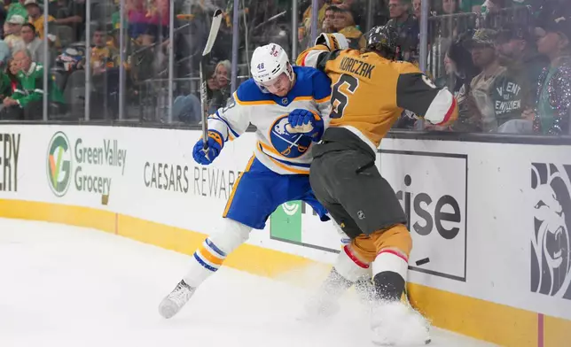 Buffalo Sabres center Tyson Kozak (48) collides with Vegas Golden Knights defenseman Kaedan Korczak (6) during the first period of an NHL hockey game Tuesday, March 17, 2026, in Las Vegas. (AP Photo/Candice Ward)