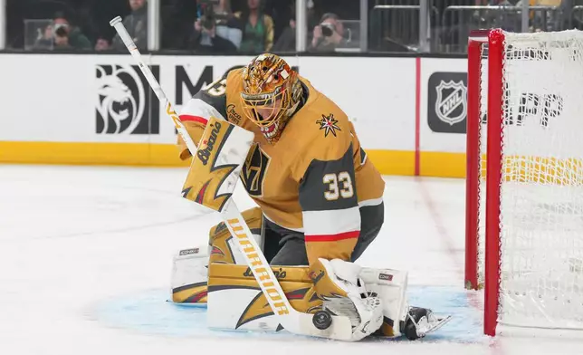 Vegas Golden Knights goaltender Adin Hill (33) stops a shot against the Buffalo Sabres during the first period of an NHL hockey game Tuesday, March 17, 2026, in Las Vegas. (AP Photo/Candice Ward)