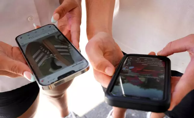 FILE - Young people use their phones to view social media in Sydney, Nov. 8, 2024. (AP Photo/Rick Rycroft, File)