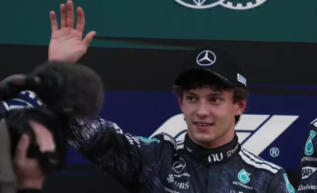 Mercedes driver Kimi Antonelli of Italy waves after the qualifying session of the Japanese Formula One Grand Prix at the Suzuka Circuit in Suzuka, Japan, Saturday, March 28, 2026. (AP Photo/Hiro Komae)