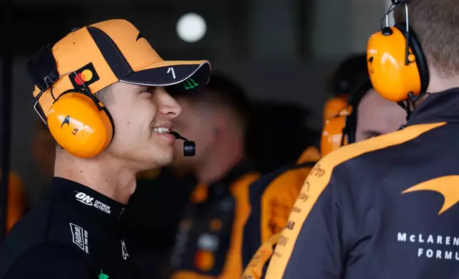 McLaren driver Lando Norris of Britain talks with team members ahead of the qualifying session of the Japanese Formula One Grand Prix at the Suzuka Circuit in Suzuka, Japan, Saturday, March 28, 2026. (Franck Robichon/Pool Photo via AP)