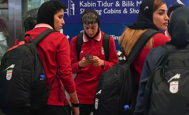 Members of Iran's women's football team arrive at the Kuala Lumpur International Airport in Sepang, Malaysia, Monday, March 16, 2026. (AP Photo/Azneal Ishak)