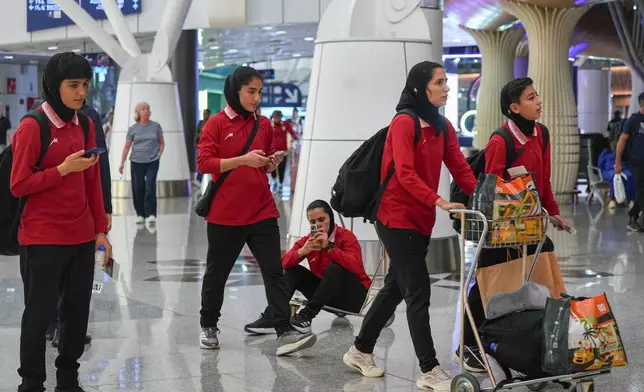 Members of Iran's women's football team arrive at the Kuala Lumpur International Airport in Sepang, Malaysia, Monday, March 16, 2026. (AP Photo/Azneal Ishak)
