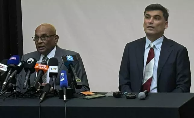 AFC General Secretary Windsor John, left, with his deputy Vahid Kardany, speaks at a news conference near Kuala Lumpur, Monday, March 16, 2026. (AP Photo/Eileen Ng)