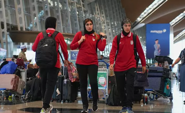 Members of Iran's women's football team arrive at the Kuala Lumpur International Airport in Sepang, Malaysia, Monday, March 16, 2026. (AP Photo/Azneal Ishak)
