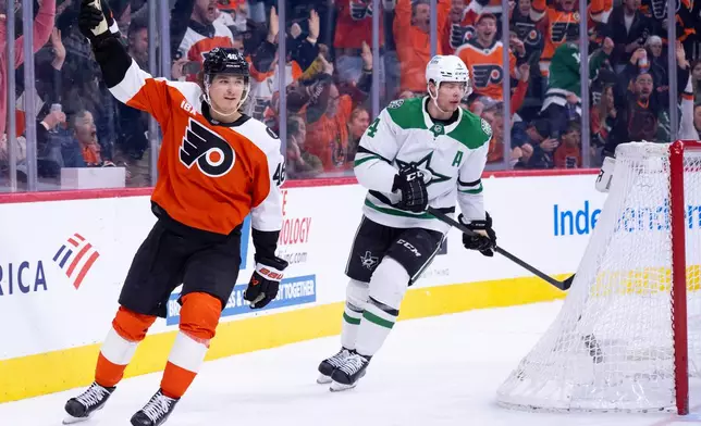 Philadelphia Flyers center Trevor Zegras, left, reacts to his game winning goal as Dallas Stars defenseman Miro Heiskanen, right, looks on during overtime of an NHL hockey game, Sunday, March 29, 2026, in Philadelphia. (AP Photo/Chris Szagola)