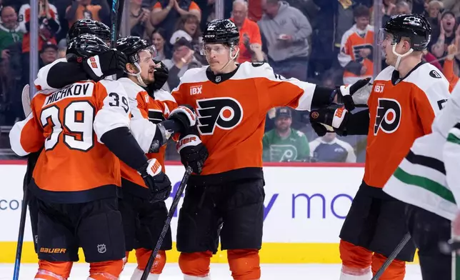 Philadelphia Flyers right winger Travis Konecny, center, celebrates his goal with tealmmates during the second period of an NHL hockey game against the Dallas Stars, Sunday, March 29, 2026, in Philadelphia. (AP Photo/Chris Szagola)