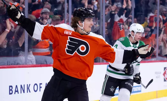 Philadelphia Flyers center Trevor Zegras, left, reacts to his game winning goal as Dallas Stars defenseman Miro Heiskanen, right, looks on during overtime of an NHL hockey game, Sunday, March 29, 2026, in Philadelphia. (AP Photo/Chris Szagola)