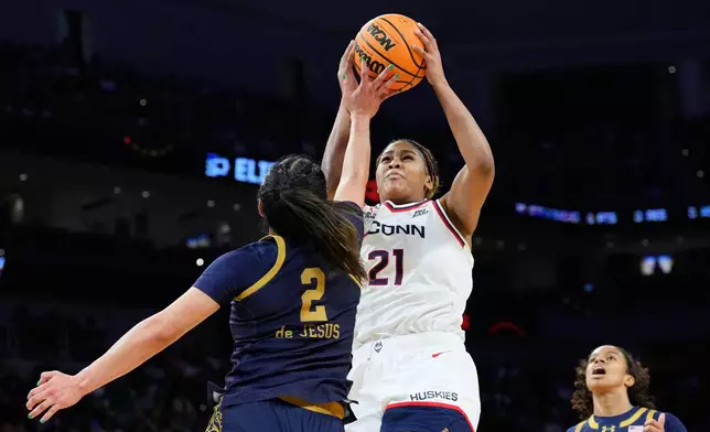UConn forward Sarah Strong (21) goes up for a basket against Notre Dame guard Vanessa de Jesus (2) during the first half in the Elite Eight of the NCAA college basketball tournament, Sunday, March 29, 2026, in Fort Worth, Texas. (AP Photo/Tony Gutierrez)