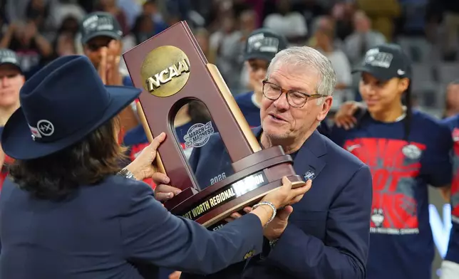 UConn head coach Geno Auriemma is presented with a Fort Worth Regional Champion trophy after his team defeated Notre Dame in the Elite Eight of the NCAA college basketball tournament, Sunday, March 29, 2026, in Fort Worth, Texas. (AP Photo/LM Otero)