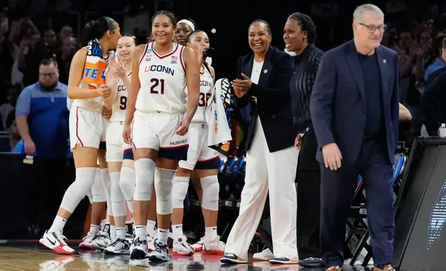 UConn forward Sarah Strong and teammates react at the end of a game against the Notre Dame in the Elite Eight of the NCAA college basketball tournament, Sunday, March 29, 2026, in Fort Worth, Texas. (AP Photo/Tony Gutierrez)