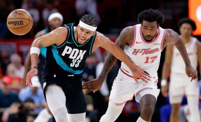 Portland Trail Blazers forward Toumani Camara (33) loses the ball while under pressure from Houston Rockets forward Tari Eason (17) during the first half of an NBA basketball game Friday March 6, 2026, in Houston. (AP Photo/Michael Wyke)