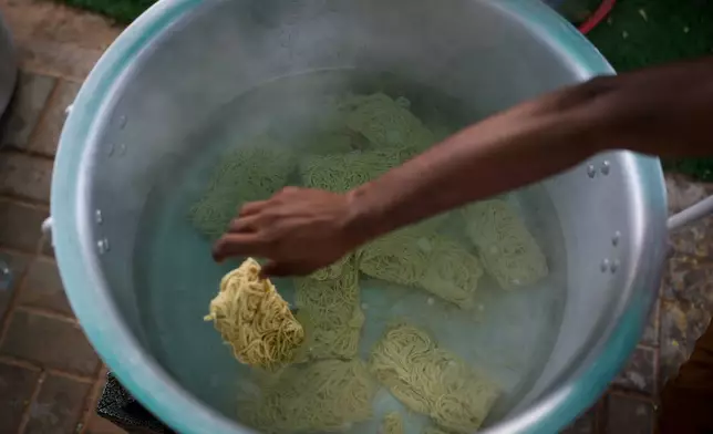 Farmhouse staff prepare food for stranded Indian travelers at a farmhouse owned by an Indian businessman, now converted into a shelter in Ajman, near Dubai, United Arab Emirates, Saturday, March 7, 2026. (AP Photo/Altaf Qadri)