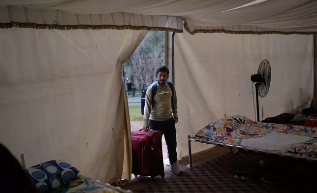 A stranded Indian traveler arrives at a farmhouse owned by an Indian businessman, now converted into a shelter in Ajman, near Dubai, United Arab Emirates, Saturday, March 7, 2026. (AP Photo/Altaf Qadri)